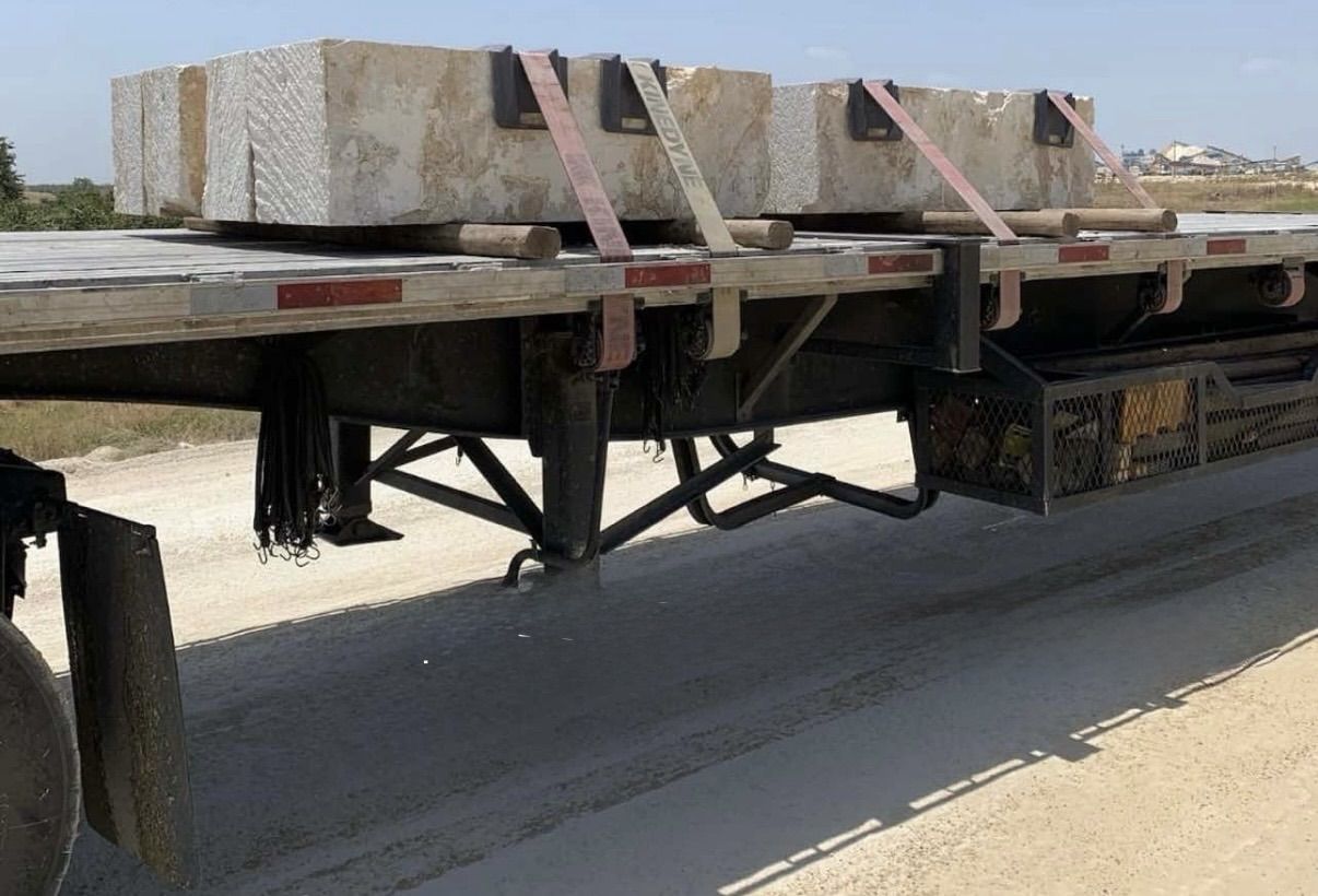 Flatbed truck loaded with limestone blocks for delivery