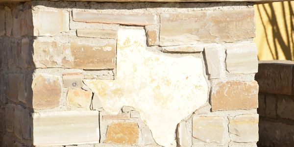 Close-up of an Oklahoma stone wall with a Texas inlay
