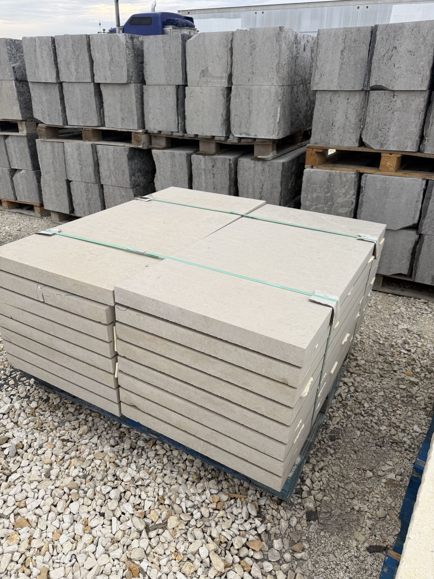 Sawn and honed limestone pavers stacked on pallets